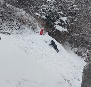 斜面で雪遊びしている